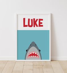 there is a shark with the word luke on it's chest and mouth, in front of a white wall