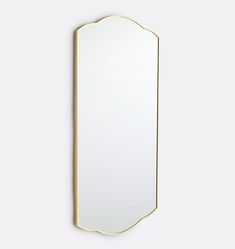 a gold framed mirror against a white wall