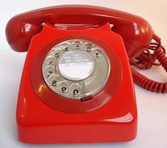 an old fashioned red telephone on a white background