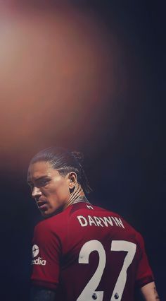 a man with long hair wearing a red shirt and number 27 on it's chest