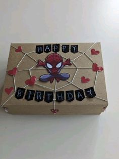 a cardboard box with the words happy birthday written on it and spiderman's face