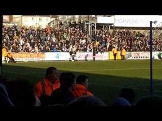 a group of people sitting on top of a soccer field