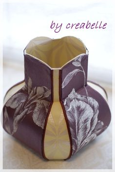 an origami vase with flowers on it