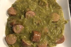 a white plate topped with meat and green sauce