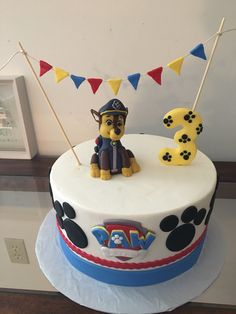 a birthday cake with a dog on top