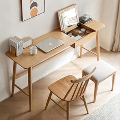 a laptop computer sitting on top of a wooden desk next to a chair and window