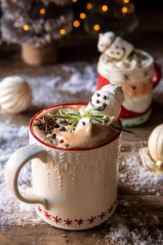 two mugs filled with hot chocolate and marshmallows