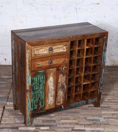 an old wooden cabinet with many drawers on it's sides and one door open