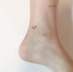 small saturn tattoo on the ankle