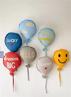 six balloons with the words lucky, smile, hello, big and little written on them