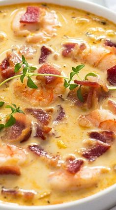 a bowl of soup with shrimp and bacon