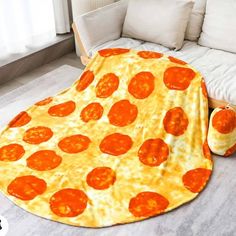 a large pizza blanket is on the floor