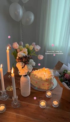 a table topped with a cake and candles