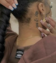 a woman with some tattoos on her neck