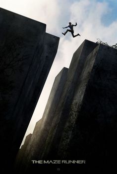 the maze runner movie poster with a person jumping off rocks into the air from between two tall buildings