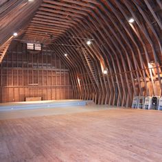 an empty wooden room with chairs in it