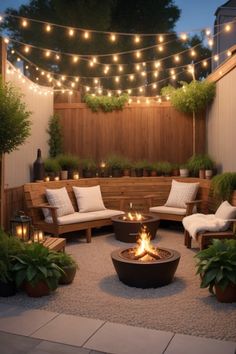 an outdoor fire pit surrounded by potted plants and lite - up string lights