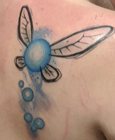 a woman's back with a tattoo design on her left shoulder and an insect drawn on it