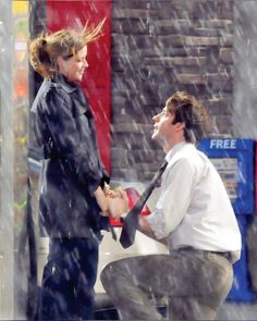 a man and woman holding an umbrella in the rain