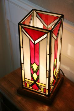 a stained glass lamp sitting on top of a wooden table