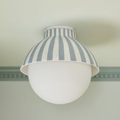 a white and blue striped lamp hanging from the ceiling