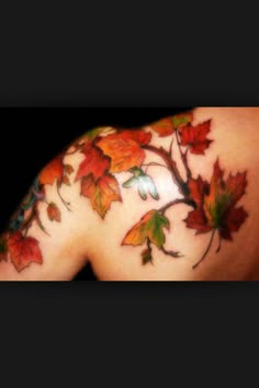 the back of a woman's shoulder with leaves painted on her arm and chest