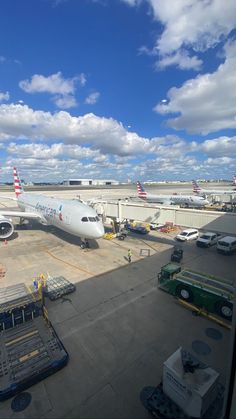 an airport tarmac with several planes parked on it