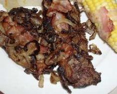 a plate with meat and corn on the cob