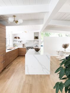 an image of a kitchen setting with white countertops and wood cabinets in the background