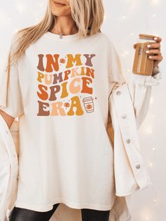 Stay cozy and show some spiced holiday spirit with this Pumpkin Spice Era Adult Fall Thanksgiving Shirt! This comfy-cozy top comes in two styles and available in sizesSMALL-3X, and features the iconic pumpkin spice vibe that is sure to bring out your Thanksgiving glow! 🎃 Plaid Jacket Women, Pumpkin Spice Shirt, Cute Shirt Designs, Autumn T Shirts, Cozy Tops, Fall Tee, Novelty Clothing, Thanksgiving Shirt, Pumpkin Shirt