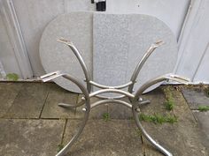 a metal chair sitting on top of a stone floor