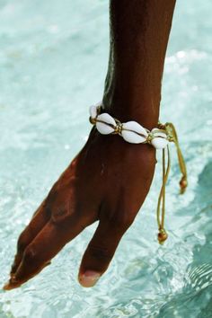 The Nara Bracelet / Anklet is handmade and consists of ties of a golden or white string overlapped with cowrie sea shells. Everything a girl could wish for.  Adjustable strap.  Sold as a separate, bracelet / anklet only.   One size only. Nara, Anklets, A Girl, Sea Shells, Shells, Bracelet, White