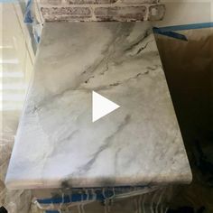 a marble counter top being installed in a room with blue tape around it and the words,