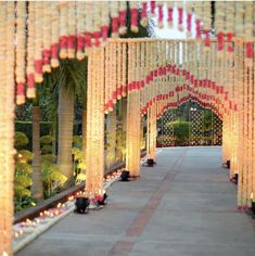 an outdoor walkway decorated with candles and streamers