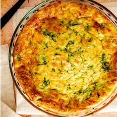 a cheesy dish with broccoli and cheese in a glass pie plate