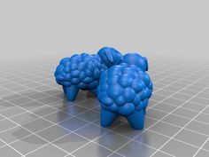 two blue sheep made out of legos on a gray surface with grids in the background