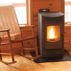 a rocking chair next to a wood burning stove