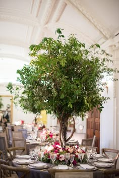 the table is set with flowers and place settings for an elegant dinner party or celebration