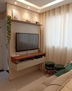 a large flat screen tv mounted to the side of a wall in a living room