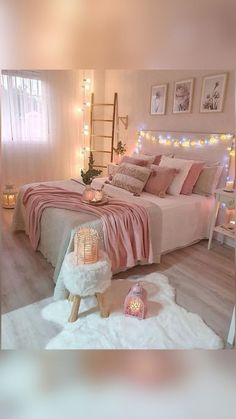 a bedroom decorated in pink and white with lights on the wall, bedding and rugs