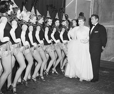 an old black and white photo of women dressed in costumes standing next to each other