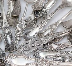 an assortment of spoons and forks with ornate designs