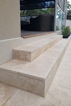 some steps leading up to a building with a pool in the background