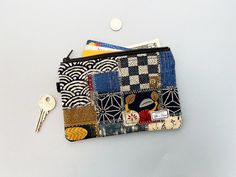 a small patchwork wallet with keys on it