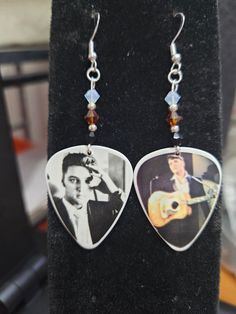 a pair of guitar pick earrings featuring elvis presley and crystal bead earwires