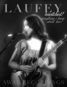 a woman holding a guitar in front of a microphone with the words laufy on it