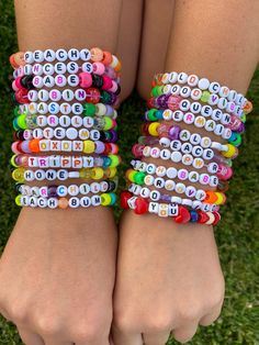 two girls wearing bracelets made out of letters and magnets on their wrists