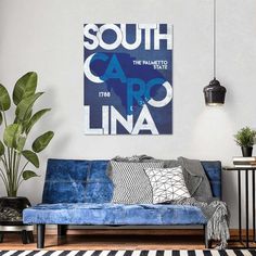 a living room with a blue couch and black and white rug