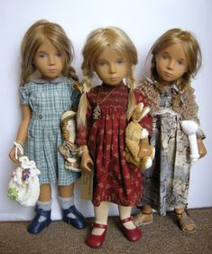 three dolls are standing next to each other