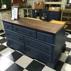 a large blue dresser sitting on top of a checkered floor